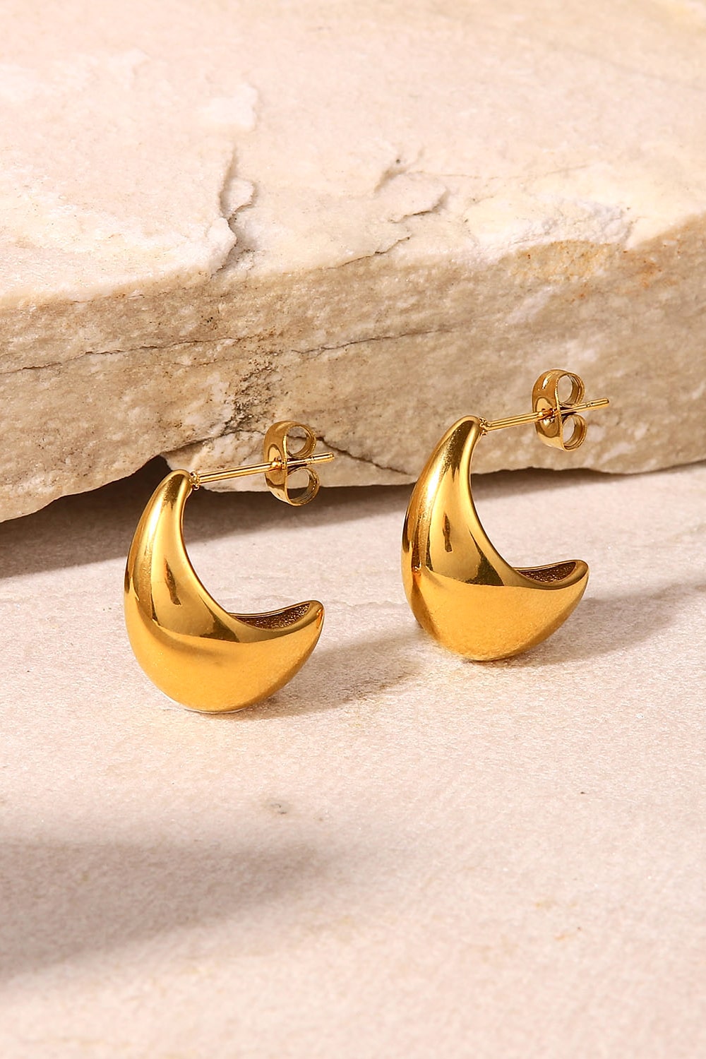 Gold sculpted crescent hoop earrings with post backs
