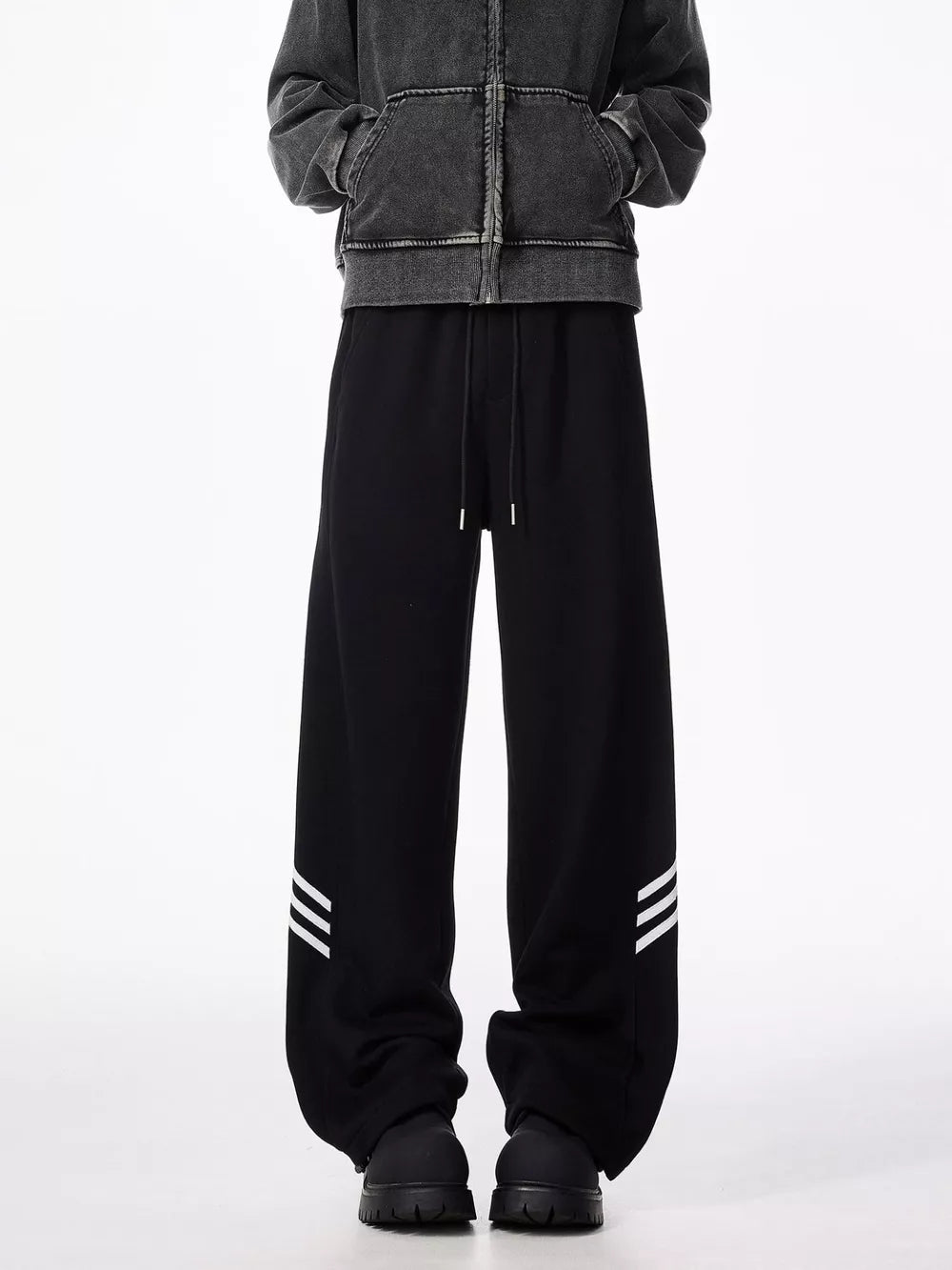 Black sweatpants with drawstring and white stripe detail on leg