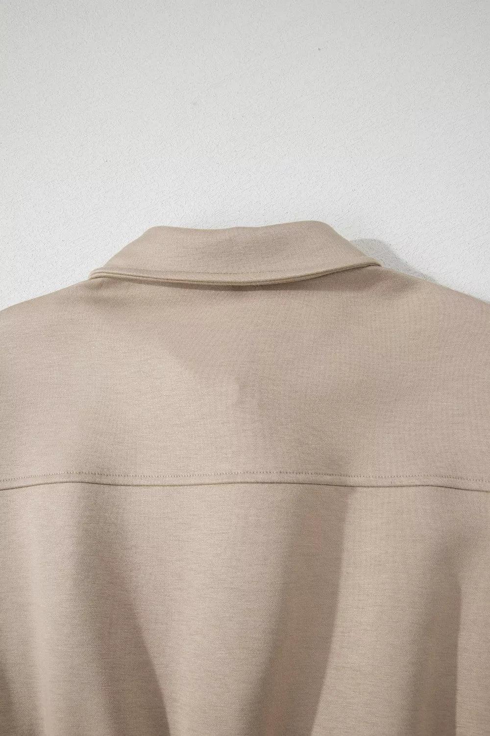 Chic collared zip front pocketed romper in beige.