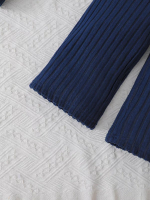 Navy ribbed knit toddler pants with scalloped hem detail.