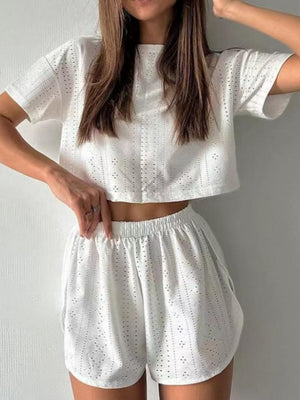 White perforated crop top and shorts set with short sleeves and elastic waist.