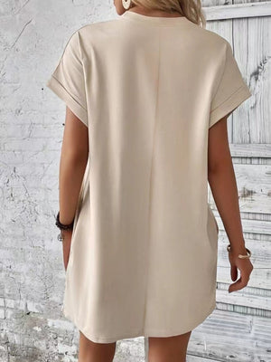 Tan relaxed tee dress with cuffed sleeves and pockets, casual midi length.