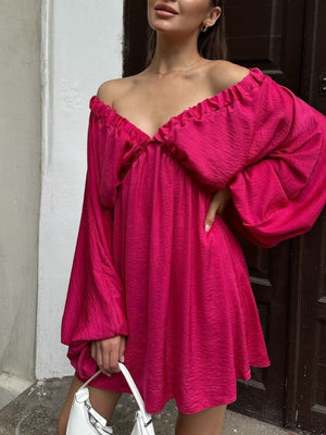 Ruched V-neck dress in deep rose with balloon sleeves and a textured fabric.