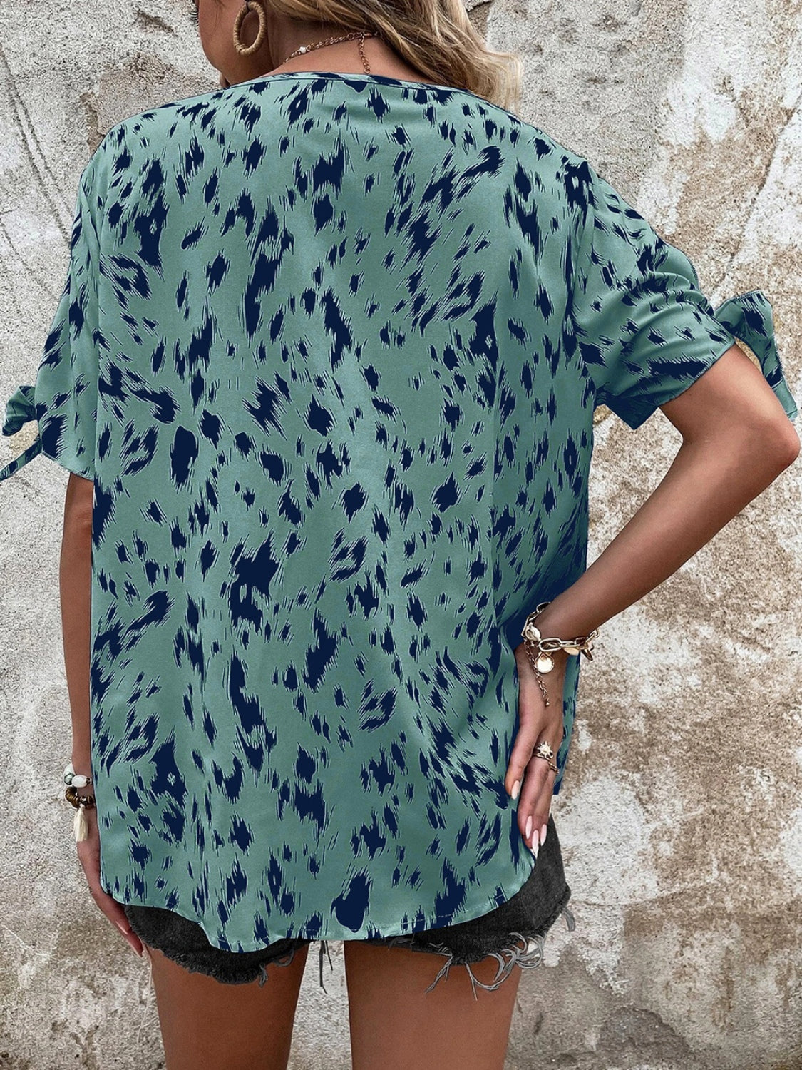 Sky blue Dalmatian print blouse with bow sleeves and a boatneck.