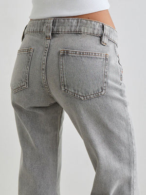Light gray cotton low rise flare leg jeans with back pockets.