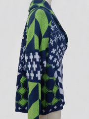 Geometric patchwork knit cardigan in navy and green with a shawl collar.