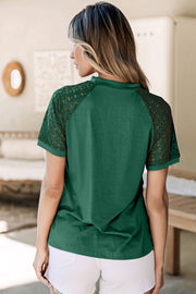 Dark green top with lace sleeves and a mock neck, shown from the back.