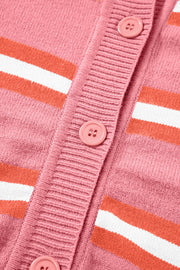 Pink knit cardigan with retro stripes and button closure.