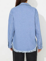 Light wash denim shirt with pearl embellishments and frayed hem.