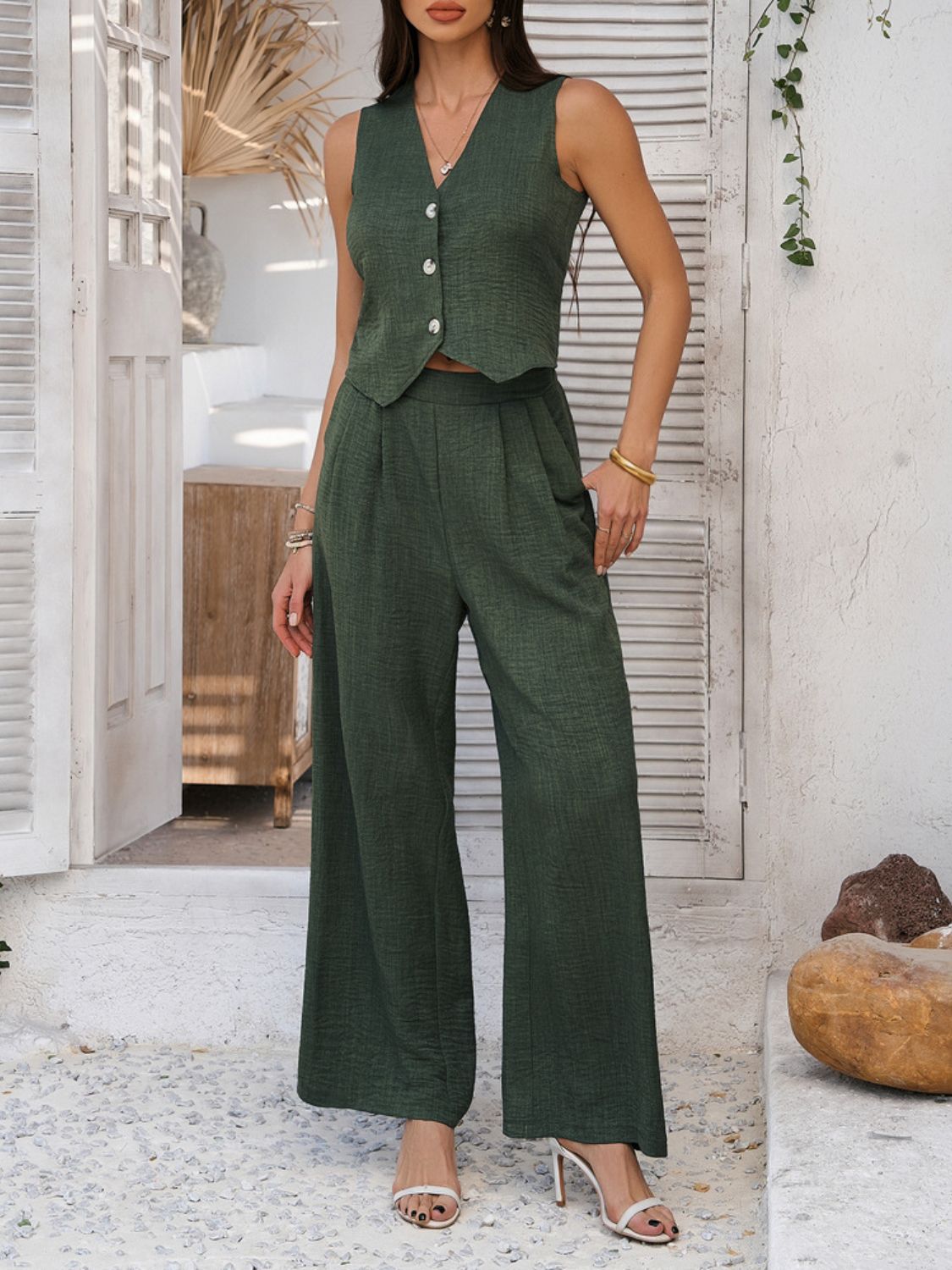 Dark green textured crop vest and wide leg pants set with button detail.