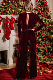 Burgundy velvet wrap jumpsuit with keyhole back and wide legs.
