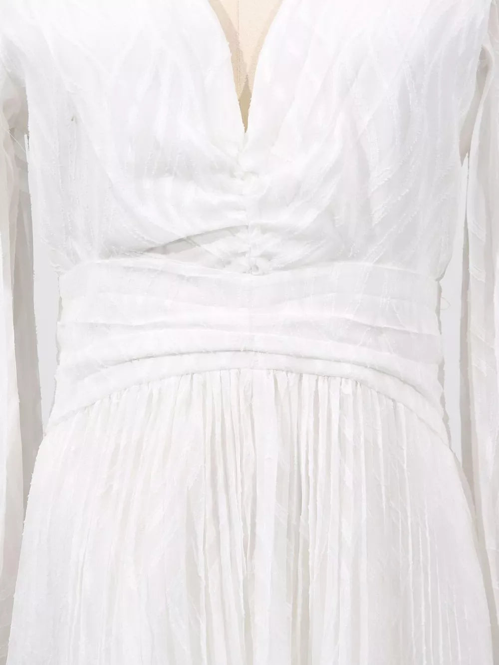 White maxi dress with ruched waist, V-neck, and textured fabric.