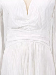White maxi dress with ruched waist, V-neck, and textured fabric.