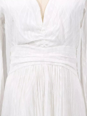White maxi dress with ruched waist, V-neck, and textured fabric.