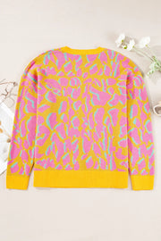 Women's crew knit sweater with abstract leopard print in fuchsia pink and mint green on yellow.