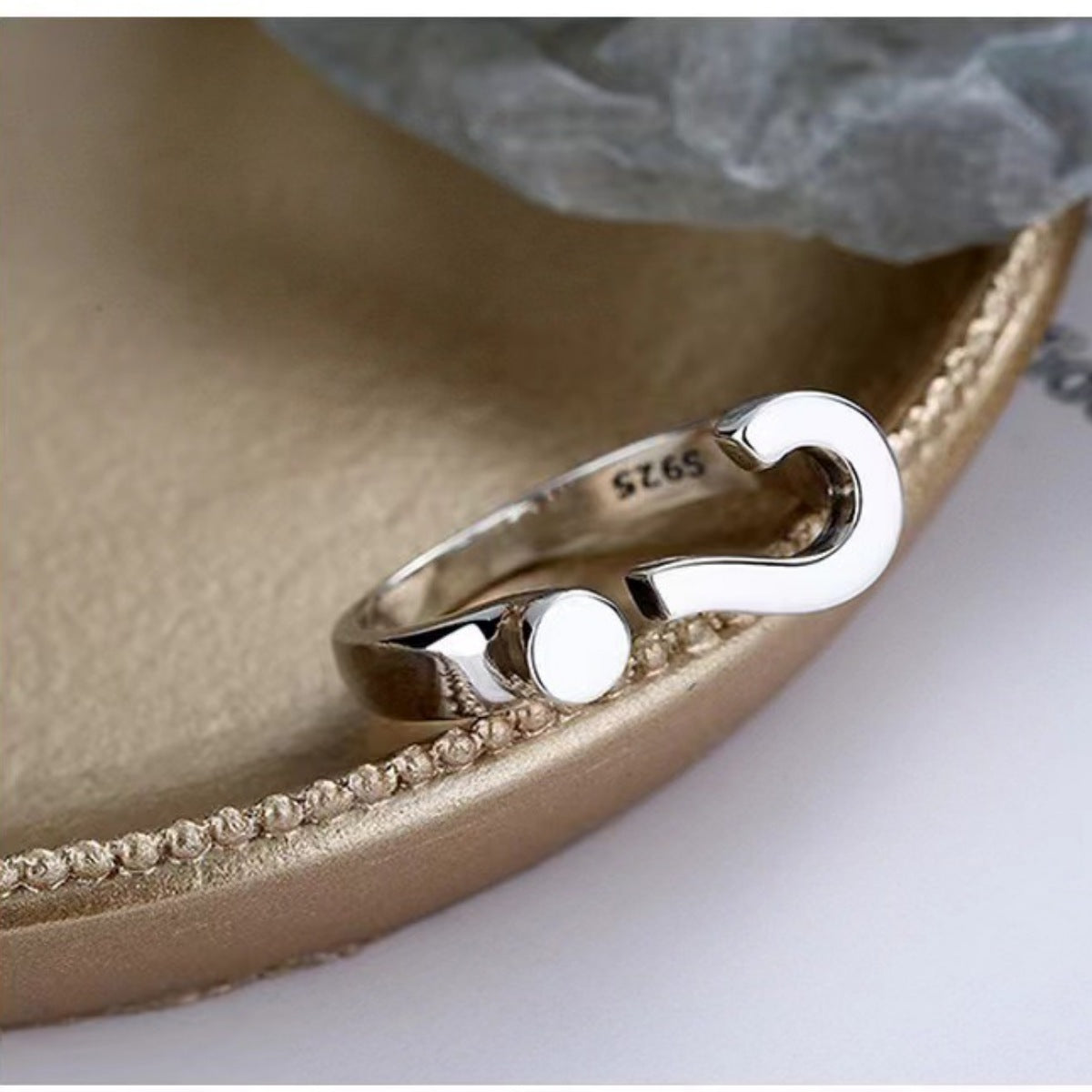 Sterling silver open ring with a question mark design and a small circle detail.