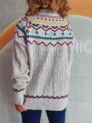 Beige cable knit turtleneck sweater with Fair Isle pattern and speckles.
