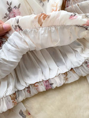 Chiffon floral blouse with ruched elastic hem and balloon sleeves detail.