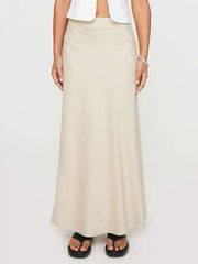 Beige bias-cut maxi skirt with a streamlined silhouette and subtle stitching detail.