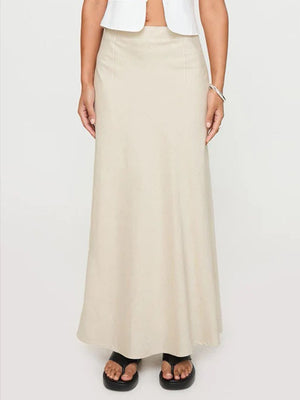Beige bias-cut maxi skirt with a streamlined silhouette and subtle stitching detail.