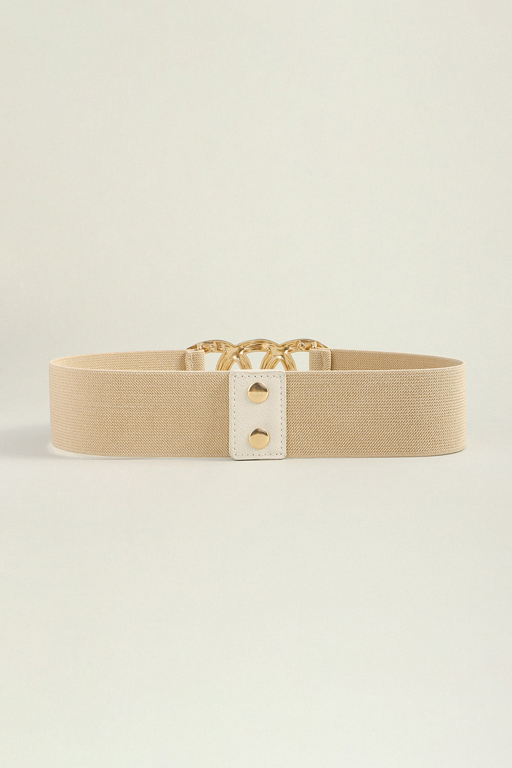 Tan elastic belt with gold triple ring buckle and white tab detail