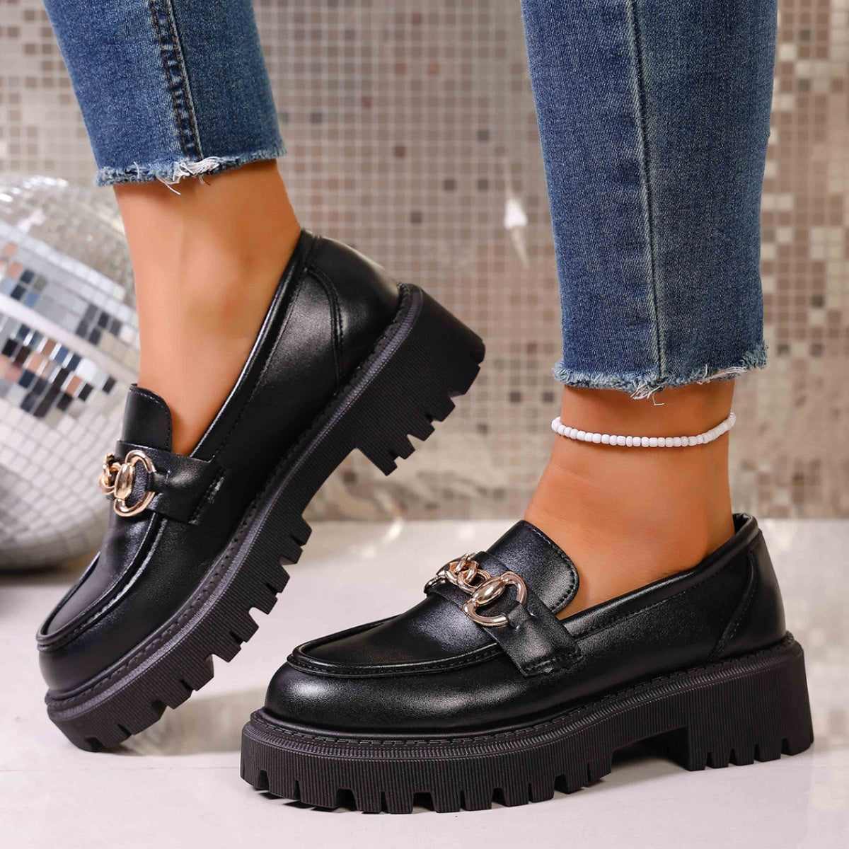 Chunky lug sole loafers in gloss black with gold chain detail and thick platform sole.