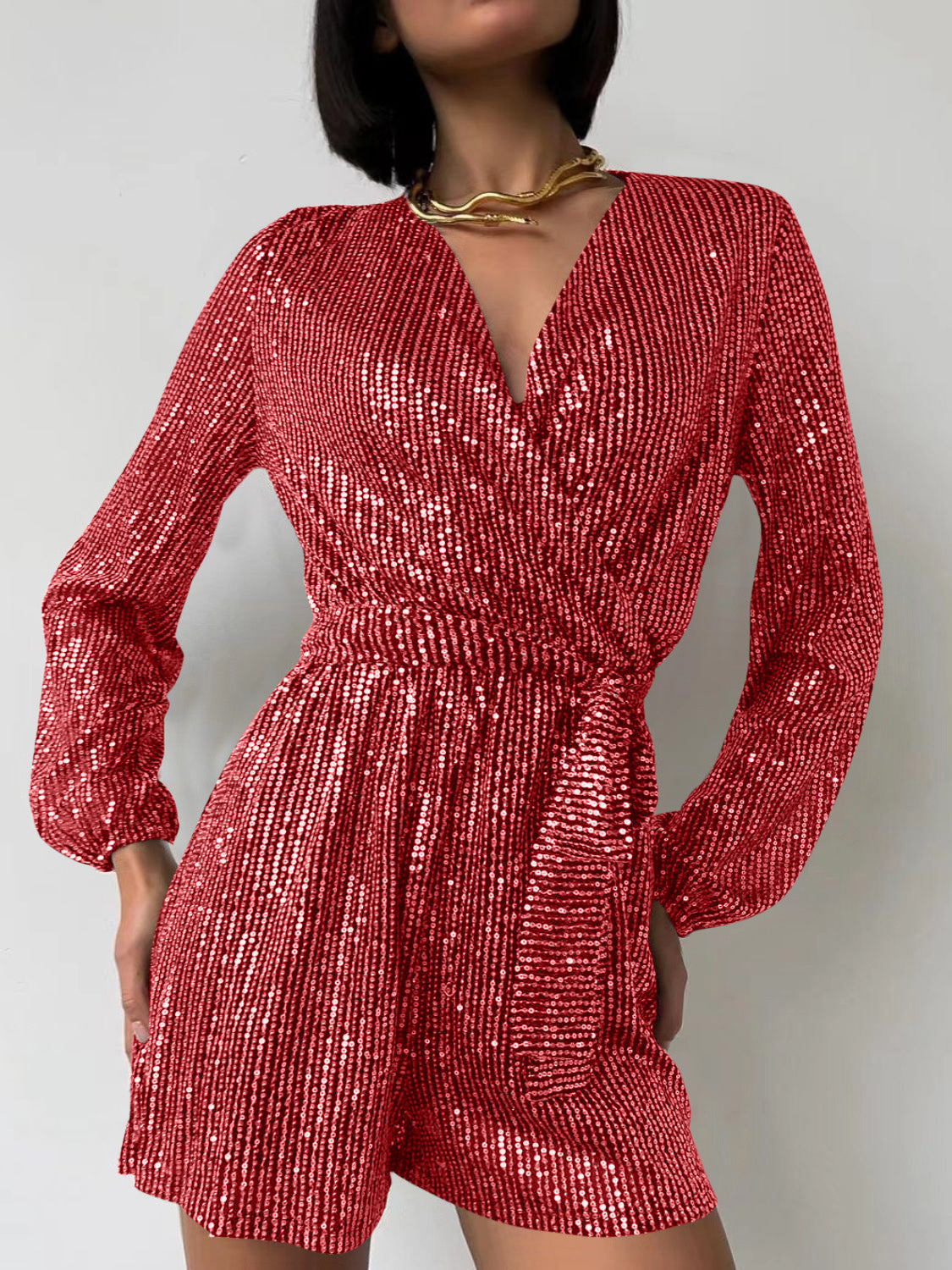 Scarlet sequin wrap romper with blouson sleeves and a tie waist.