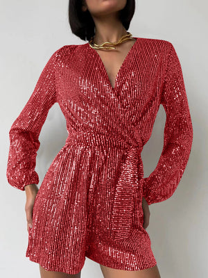 Scarlet sequin wrap romper with blouson sleeves and a tie waist.