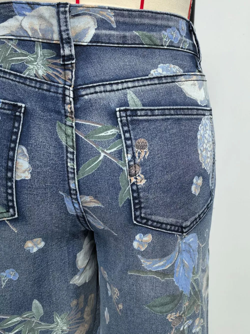 Denim shorts in blue with a botanical print and relaxed fit.