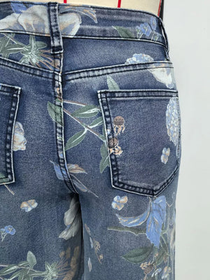 Denim shorts in blue with a botanical print and relaxed fit.