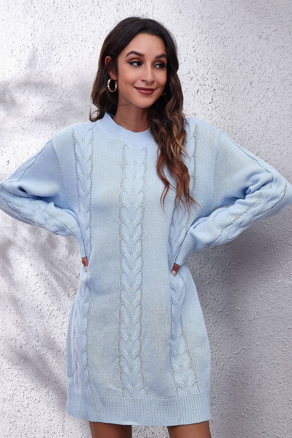 Light blue cable knit sweater dress with crewneck and long sleeves.