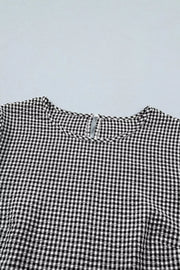 Black and white gingham polyester shirt with ruffled detail and keyhole back.