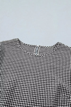 Black and white gingham polyester shirt with ruffled detail and keyhole back.