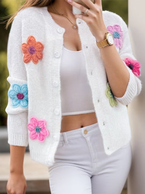 White textured knit cardigan with colorful embroidered flowers and button front.