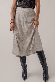 Dotted bias-cut midi skirt in heather gray, styled with black boots.