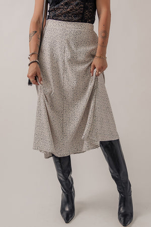 Dotted bias-cut midi skirt in heather gray, styled with black boots.