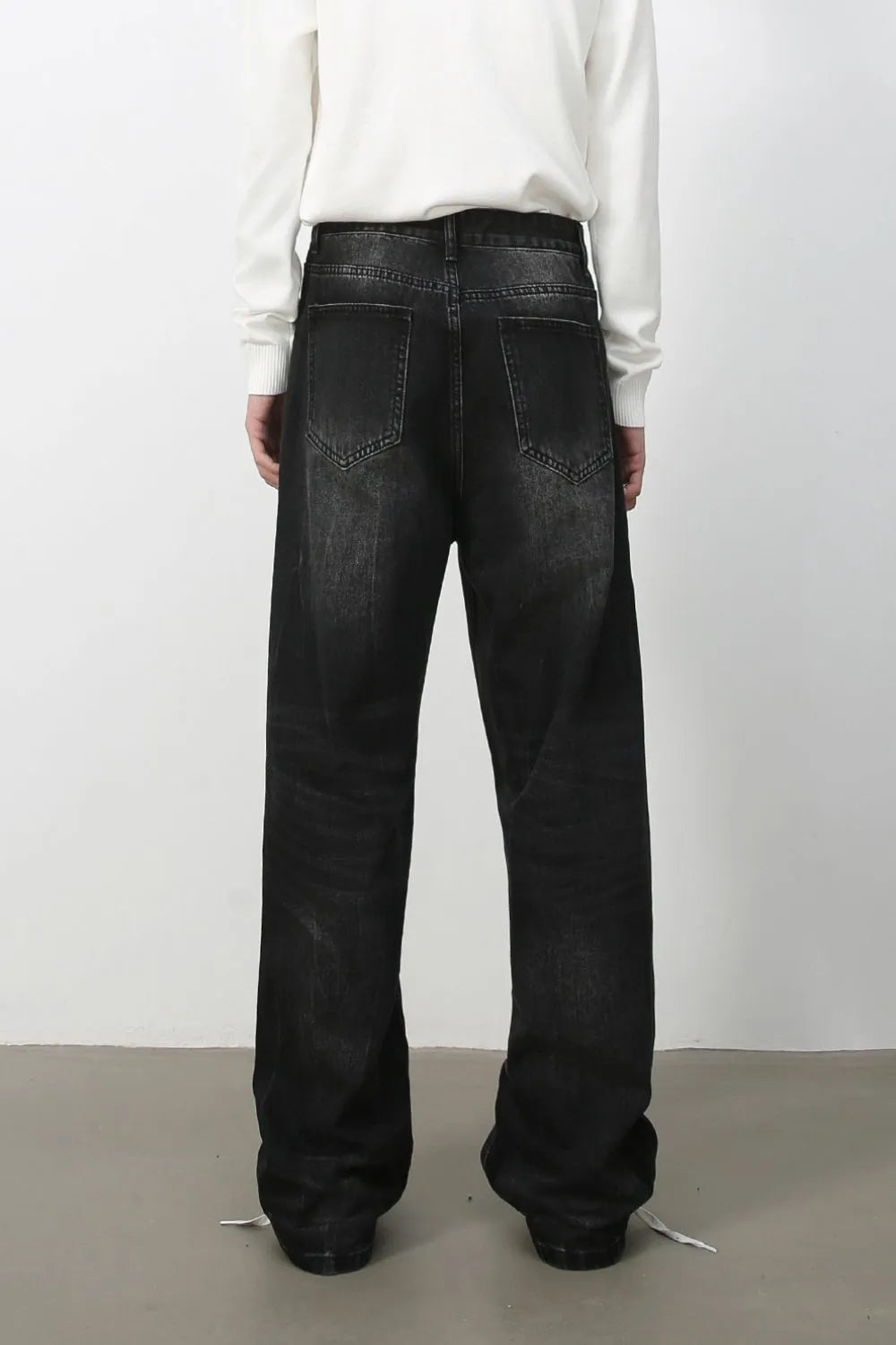 Wide-leg distressed denim jeans in dark vintage wash with a relaxed fit.