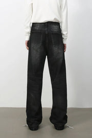Wide-leg distressed denim jeans in dark vintage wash with a relaxed fit.