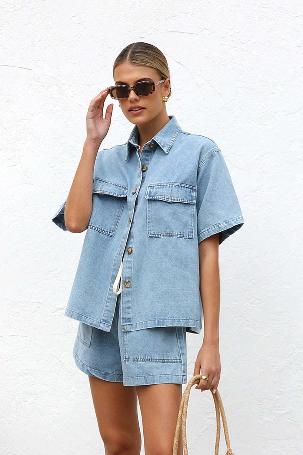 Light wash denim short sleeve button-up shirt and drawstring shorts set with chest pockets.
