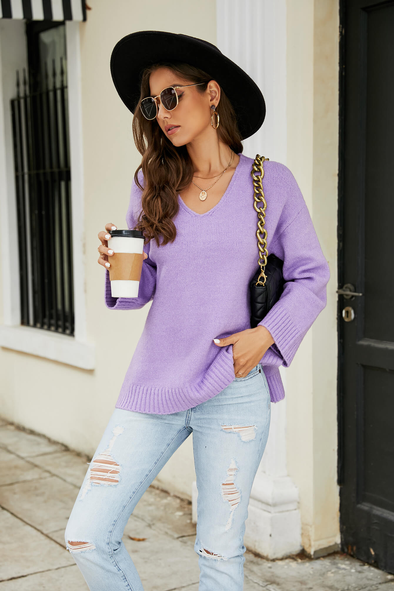 Relaxed fit lavender V-neck knit pullover sweater with ribbed cuffs and hem.