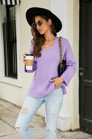 Relaxed fit lavender V-neck knit pullover sweater with ribbed cuffs and hem.