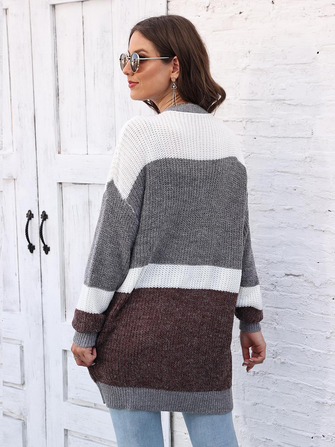 Colorblock knit open cardigan with white, gray, and brown stripes.
