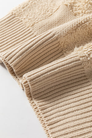 Beige acrylic sweater with textured checkerboard knit detail and ribbed cuffs.
