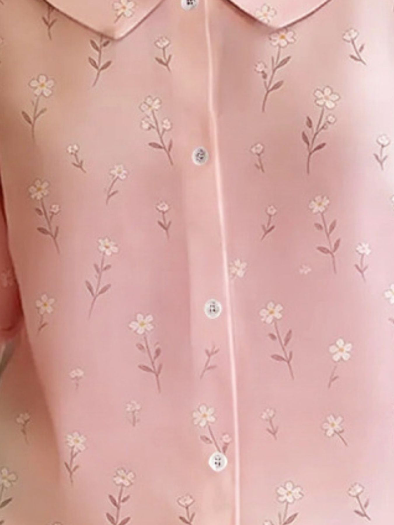 Peter Pan collar blouse in dusty pink with a delicate floral print and button-down front.