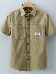Men's short-sleeve cotton shirt in Apricot with two chest pockets and button front.