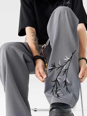 Men's light gray wide-leg sweatpants with embroidered branch detail