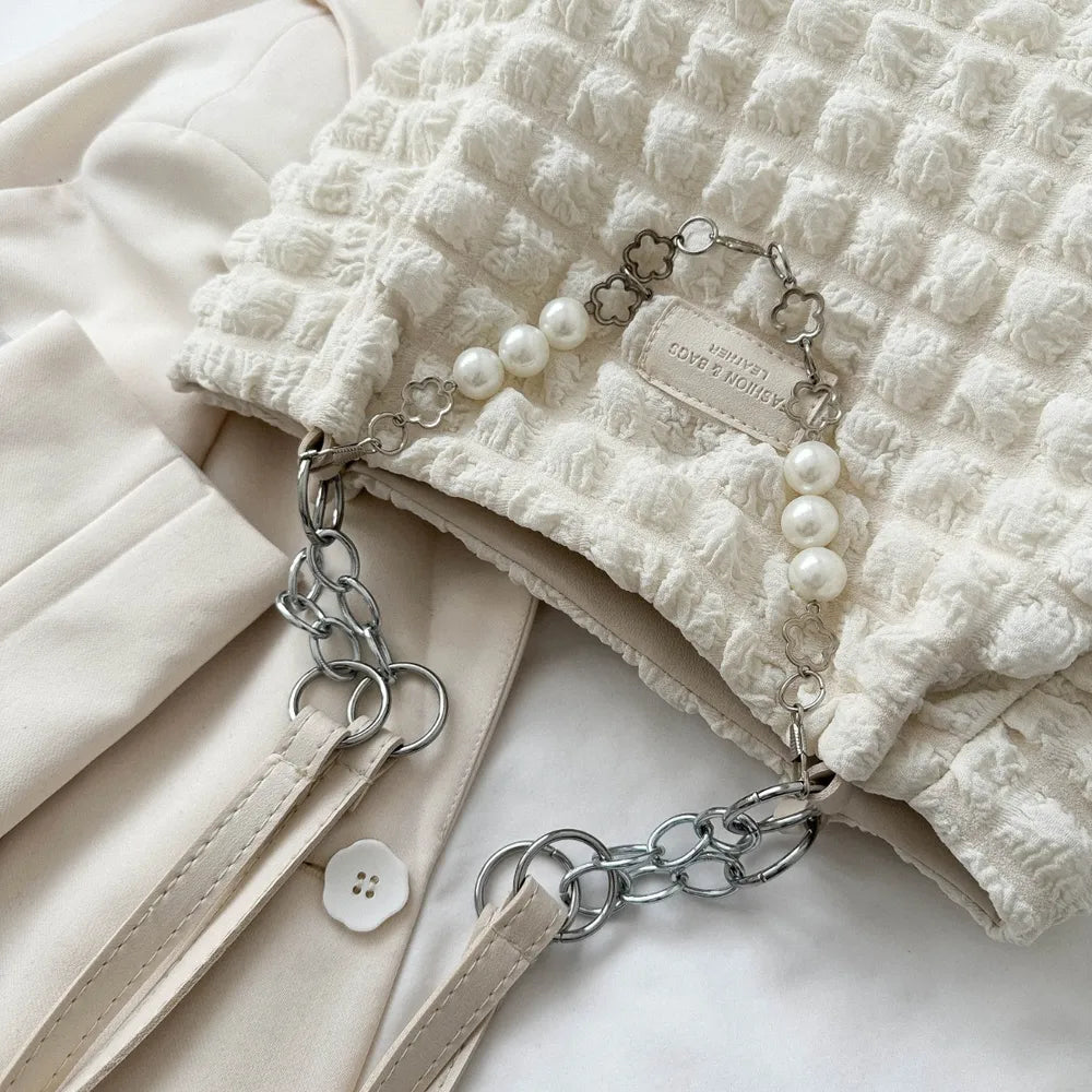 Textured grid pearl chain tote in ivory with silver chain detail and faux pearl accents.