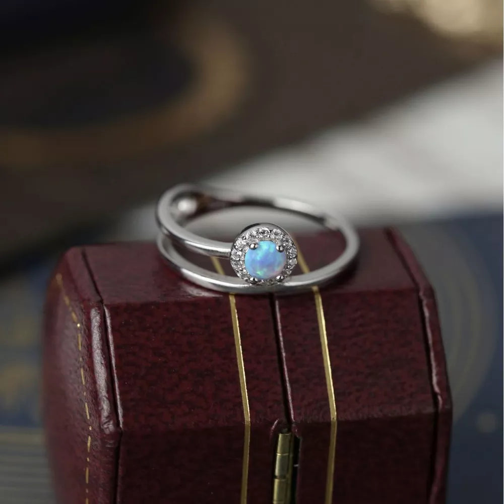 Iridescent opal halo ring with double band in 925 sterling silver.
