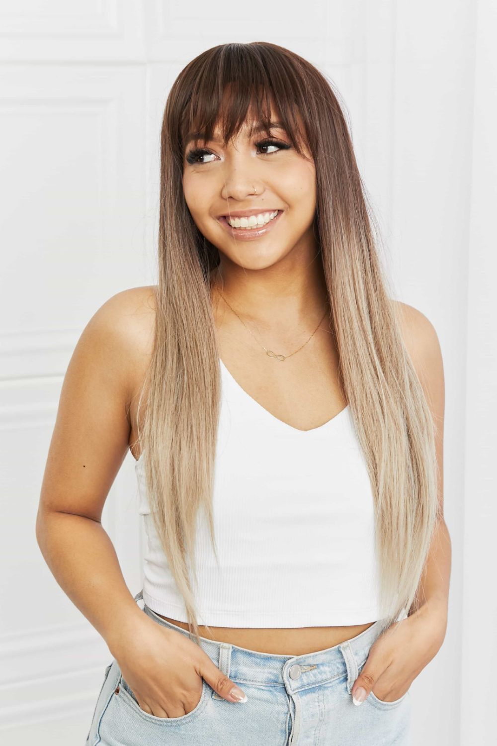 Ombre fringe synthetic hair extension in black to gray, styled with bangs and straight, long hair.