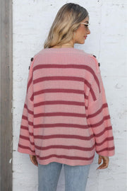 Pink striped knit pullover sweater with button shoulder detail.